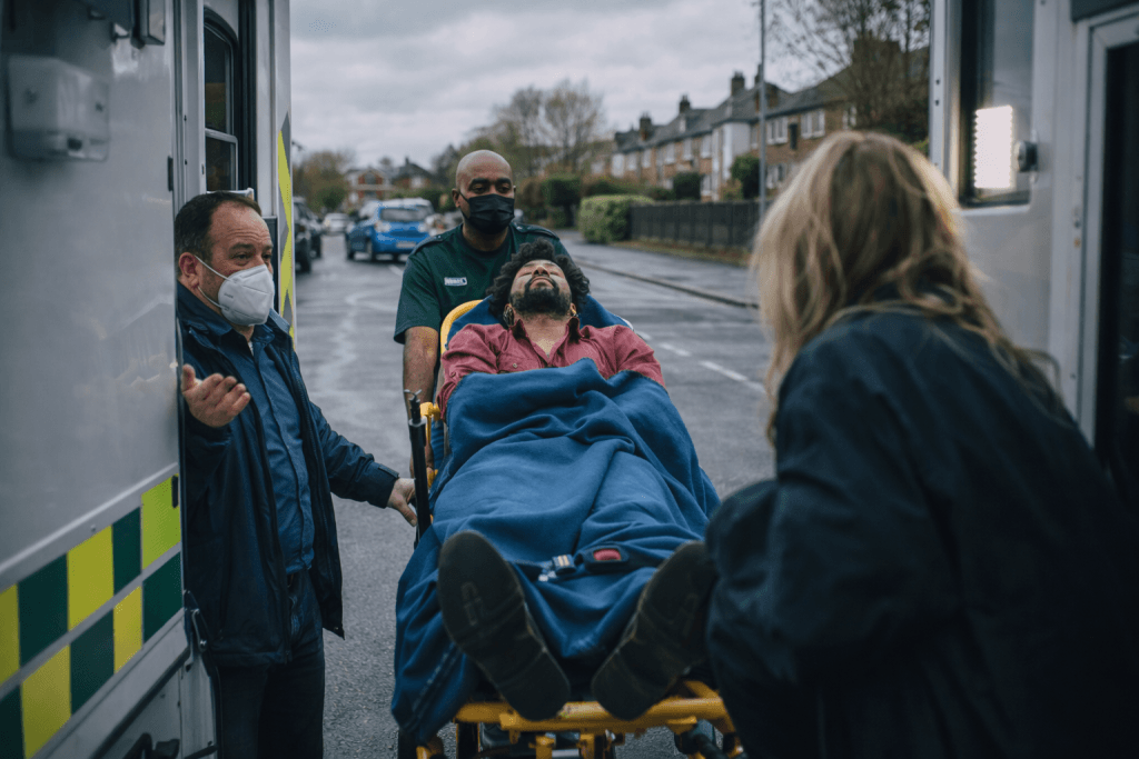 A man being helped into an ambulance