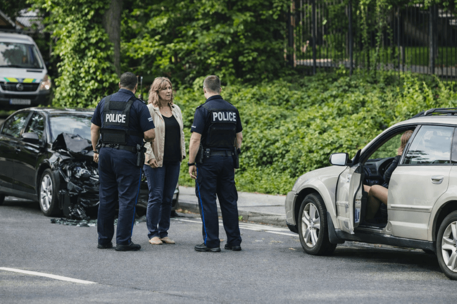 A woman talking to police at the scene of a car accident