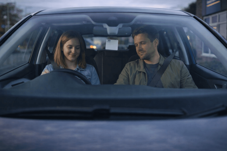 A man and woman sitting in their hire car