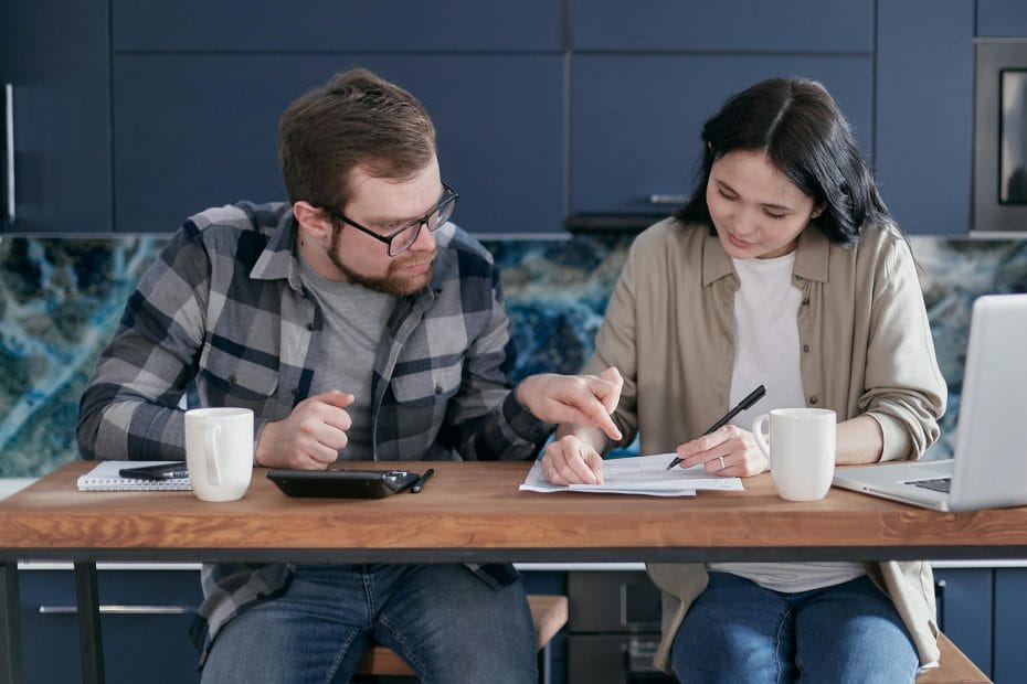Adult couple reviewing bills and managing finances at home.
